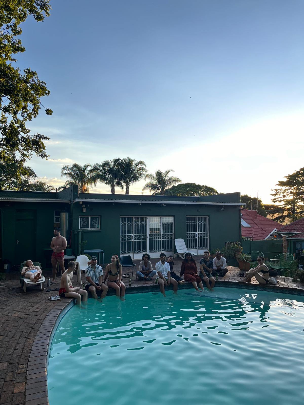 Guests around the swimming pool at dusk